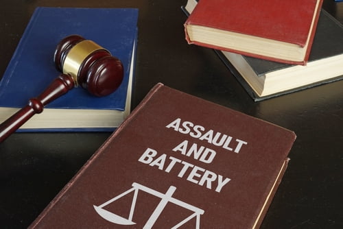 Book with the words assault and battery representing Tennessee assault law