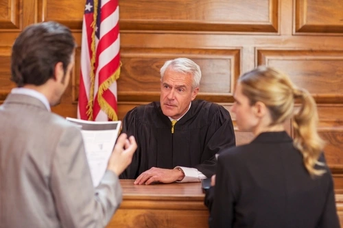 A criminal defense attorney presents a case in a courtroom.