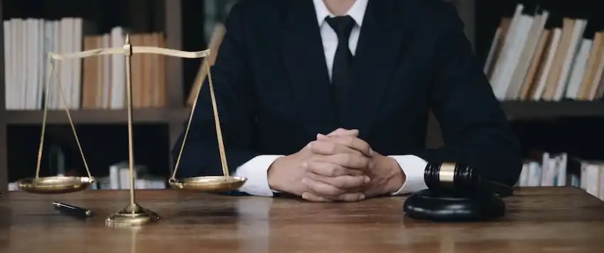 Nashville criminal defense attorney Jeffrey Jackson at a desk with a set of justice scales ready to defend a case.