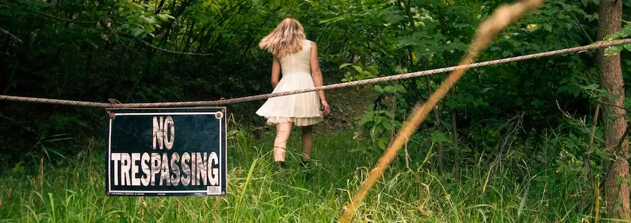 A woman needs a property crimes lawyer after trespassing on someone's property.